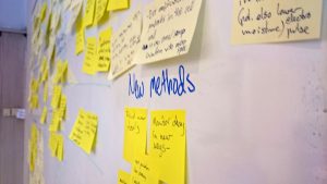 Close up on white board with post-it's on it. 