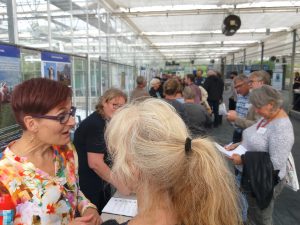 People mingeling at exhibition. Photo.