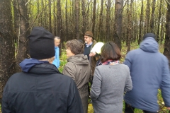 Group of people outside in forest. Photo.