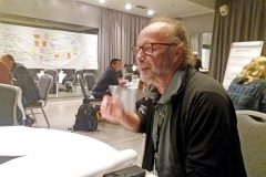 Man sitting at white table. Photo.