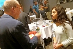 Older man and younger woman talking. Photo.