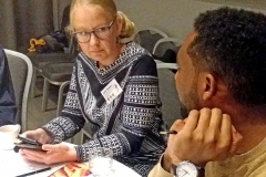 Woman and a man sitting at a table. Photo.