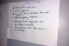 White paper with black text naild to a wall. Photo.