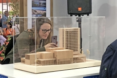 Woman looking at model. Photo.