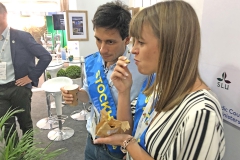 Man and a woman with blue ribbons standing next to each other. Photo.