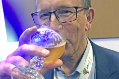 Man in glasses drinking beer. Photo.